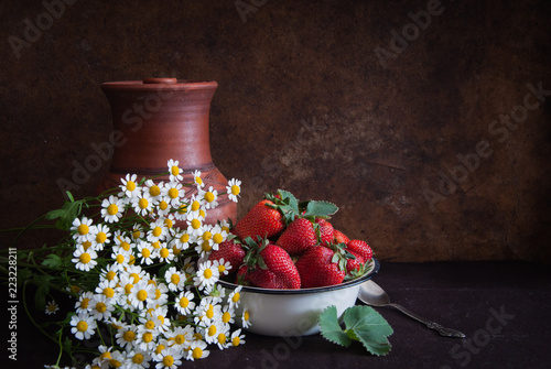 Strawberry, ceramic jug and daisies in the style of Dutch still life
