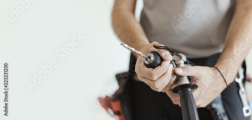 Professional handyman changing a drill bit