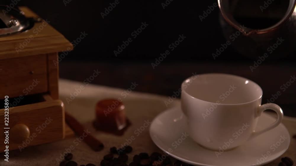 Slow motion pouring coffee from a silver pot Slow motion pouring coffee from a silver pot