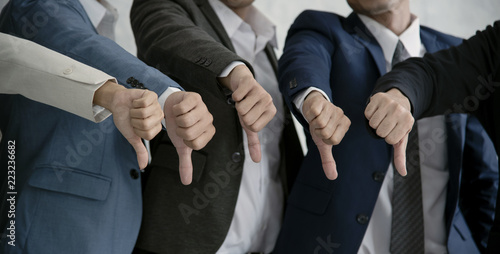 group businesspeople thumbs down together. concept rejection and boycott. photo