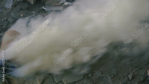 Smoke grenade. Smoke grenade smokes on the floor photo