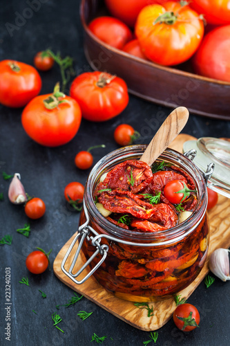 Sun dried tomatoes with garlic and olive oil in a jar