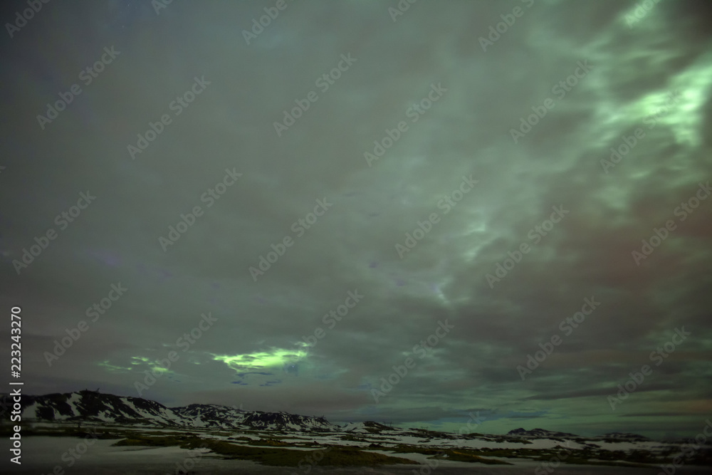 Fototapeta premium The northern lights pierce the clouds