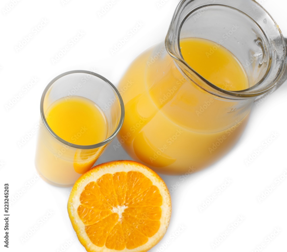 Pitcher and glass of freshly squeezed orange juice Pitcher and glass of freshly squeezed orange juice