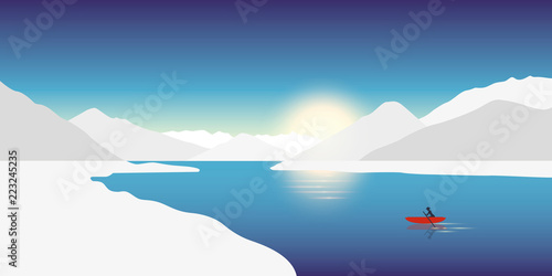 lonely canoeing adventure concept red boat in a winter landscape with snowy mountains