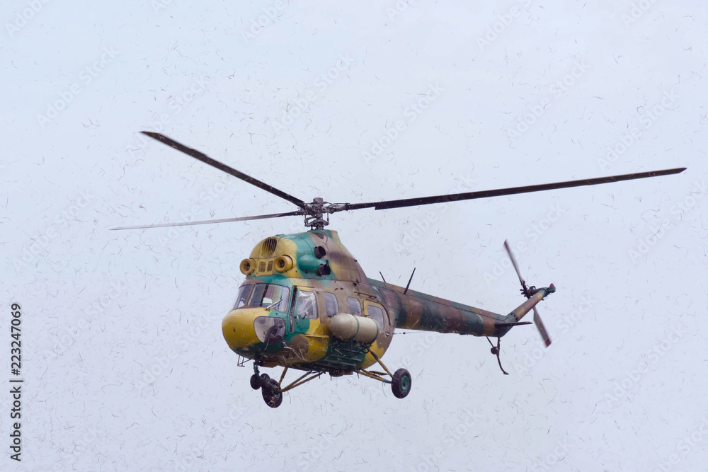 Fototapeta premium The helicopter is in the air. Helicopter in motion around it is dust.