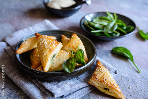 Spanakopita triangles stuffed with spinach and Feta cheese photo