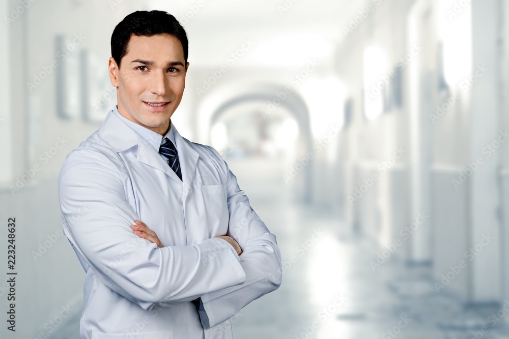 Handsome young male doctor in uniform standing Handsome young male doctor in uniform standing
