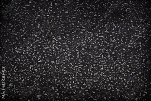 the dark gray asphalt texture background rocks interspersed with gravel