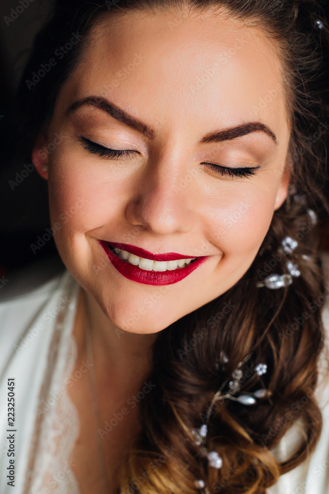 beautiful bride closed her eyes and on her face is a gentle makeup and a red lipstick beautiful bride closed her eyes and on her face is a gentle makeup and a red lipstick