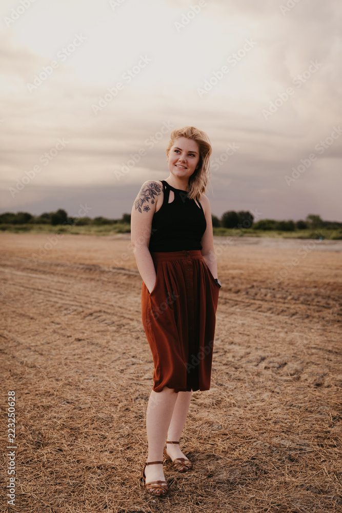 Cute Young Female Model with Short Hair and Freckles Modeling in a Bare Field Cute Young Female Model with Short Hair and Freckles Modeling in a Bare Field