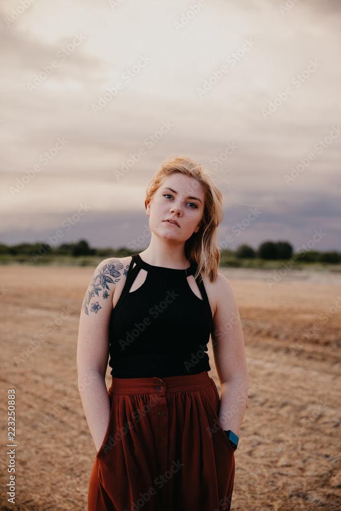 Cute Young Female Model with Short Hair and Freckles Modeling in a Bare Field Cute Young Female Model with Short Hair and Freckles Modeling in a Bare Field