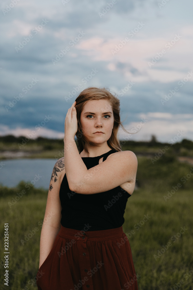 Cute Young Female Model with Short Hair and Freckles Modeling in a Bare Field Cute Young Female Model with Short Hair and Freckles Modeling in a Bare Field