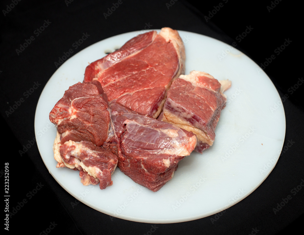 Fresh, juicy meat on a white board