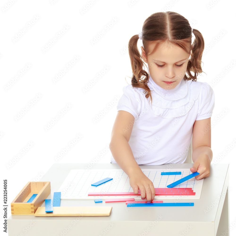 A little girl is studying Montessori stuff. A little girl is studying Montessori stuff.