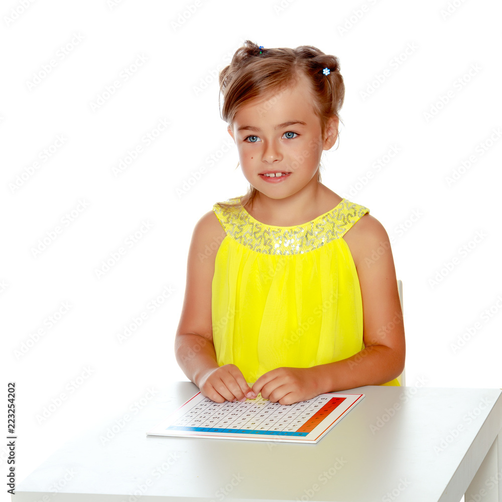 A little girl is studying Montessori stuff. A little girl is studying Montessori stuff.