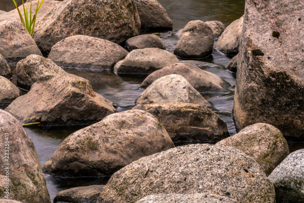 long exposure of a river with rocks in between long exposure of a river with rocks in between