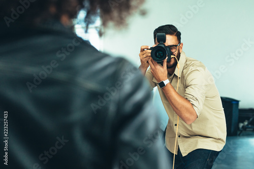 Photographer doing a photo shoot in a studio photo