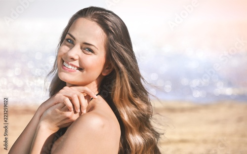 Young woman relaxing on beach background