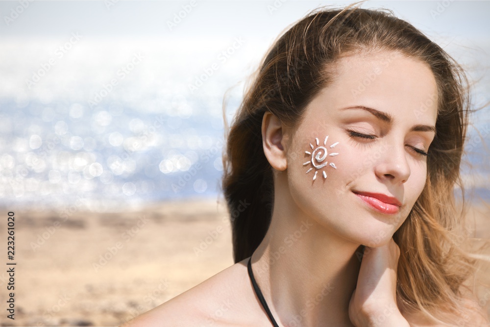 Beautiful Woman with Sunscreen Solar Cream over Beautiful Woman with Sunscreen Solar Cream over