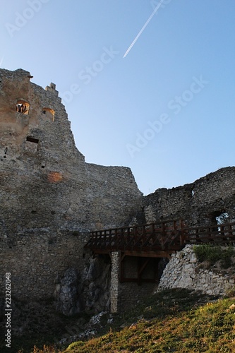 Wooden bridge on support pillar as entrance to inner courtyard of early gothic part of castle Topolcany, Slovakia photo