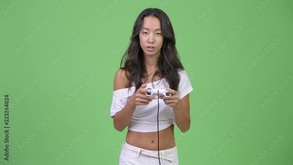 Young tired multi-ethnic woman playing games and falling asleep Young tired multi-ethnic woman playing games and falling asleep