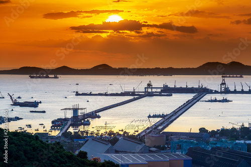 Dramatic Sky burst over Sriracha harbor port Chonburi Thailand, long exposure technic therefore smooth water surface 