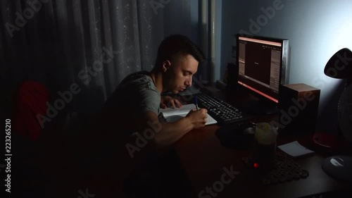 A university or college student studies and writes notes at night