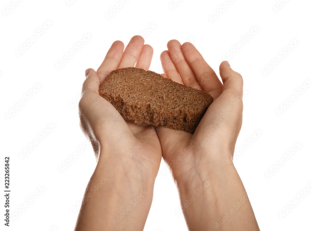 Poor woman holding piece of bread on white background, closeup Poor woman holding piece of bread on white background, closeup