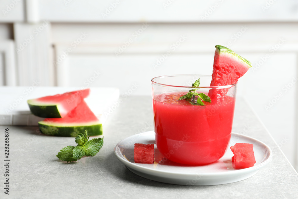 Summer watermelon drink with mint in glass served on table Summer watermelon drink with mint in glass served on table