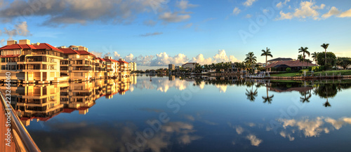 Reflection in the water of buildings along the Village at Venetian Bay