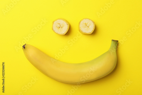 Funny flat lay composition with bananas on color background