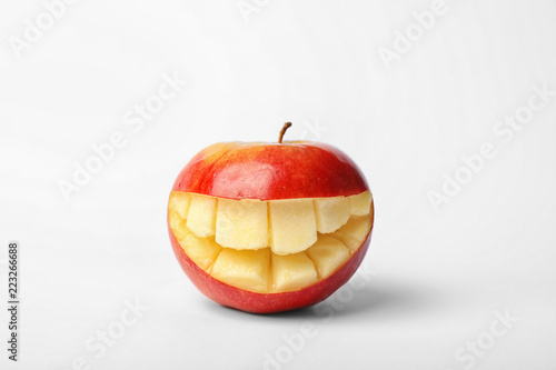 Funny smiling apple on white background