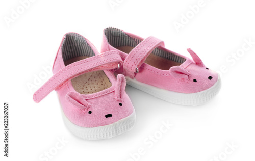 Cute pink child shoes isolated on white