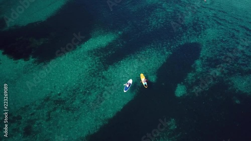 Wallpaper Mural Video from above, aerial view of  two people on a stand up paddle (SUP) in Sardinia, Italy. Torontodigital.ca