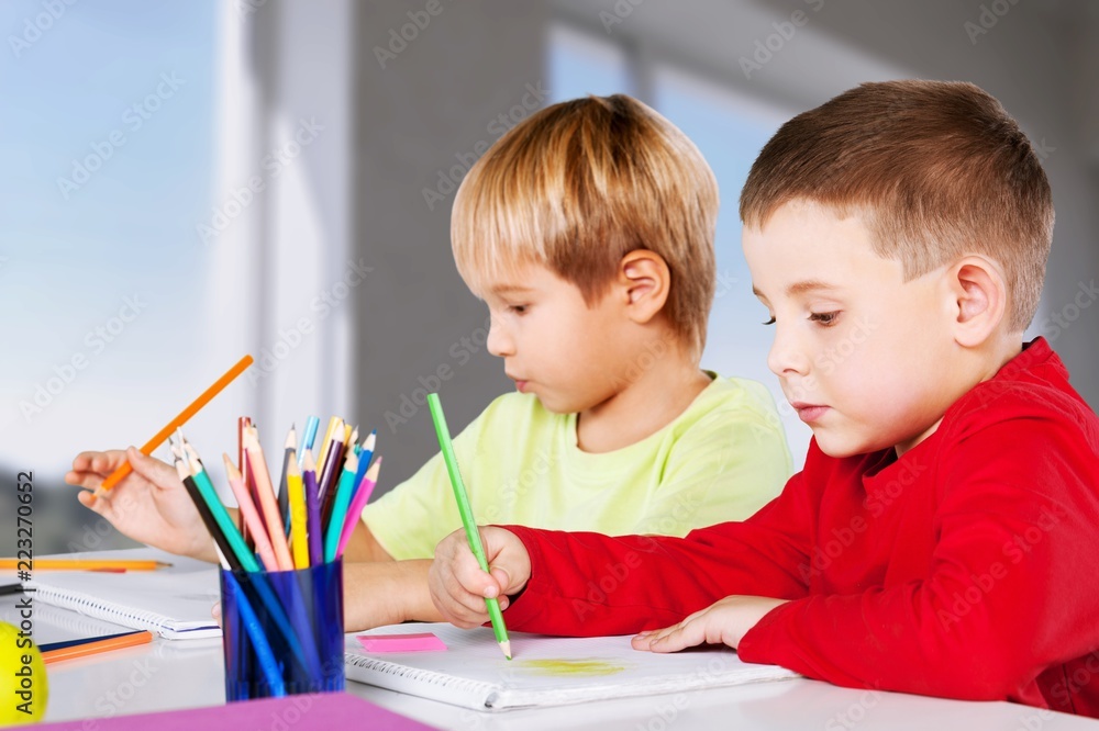 Two little boys studying subject on background Two little boys studying subject on background