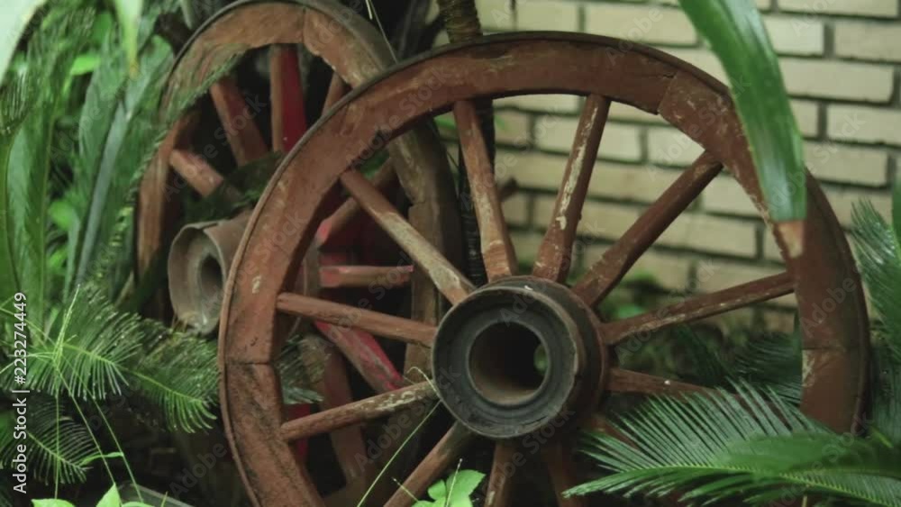 Garden adorned with antique wagon wheel. Garden adorned with antique wagon wheel.