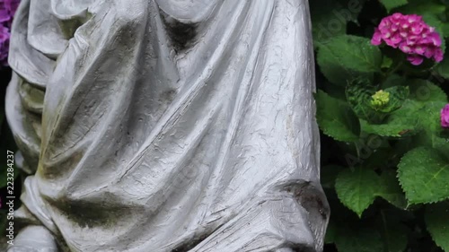 Full tilt of woman statue holding a child close up