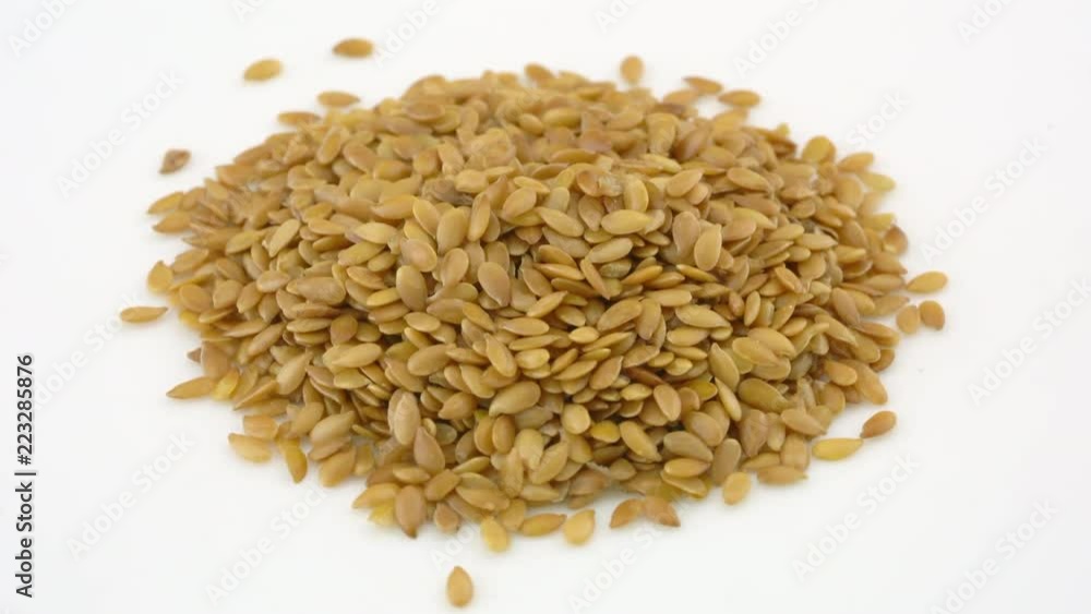 Golden flax seeds - closeup of rotating background Golden flax seeds - closeup of rotating background