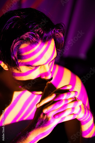 Cinematic portrait of man in yellow and purple lines, projecto