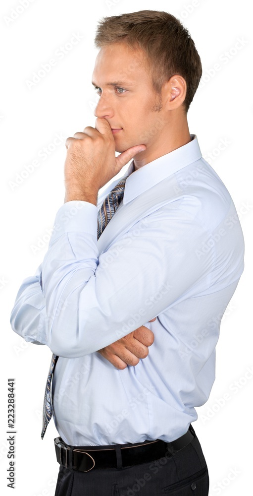 Professionally dressed male standing and thinking
