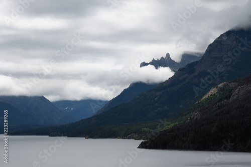 Misty clouds rise over Upper Waterton Lake mountain peaks in Waterton Lakes National Park, Canada