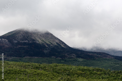 Misty clouds rise over mountain peaks in Waterton Lakes National Park, Canada