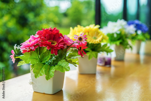 colorful decoration artificial flower in pot on table