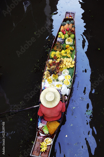 Photography Woman trading fruit and food in boats at Damnoen Saduak floating market ,Thailan