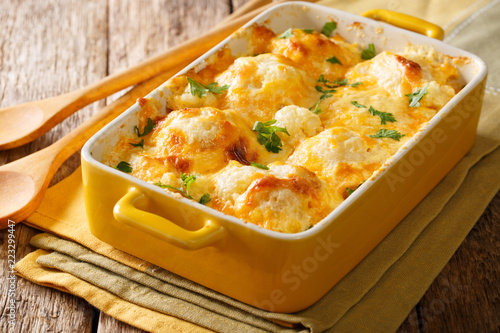 Savory food: baked cauliflower with cheese, eggs and cream close-up in a baking dish. horizontal