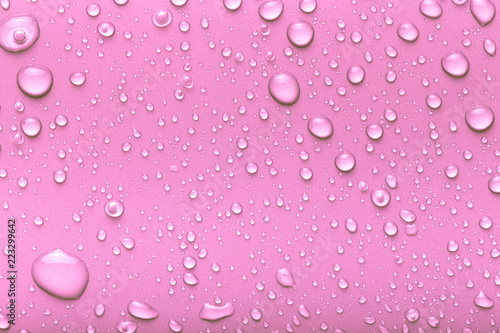 Drops of water on a color background. Pink. Toned