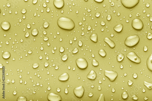 Drops of water on a color background. Yellow. Toned