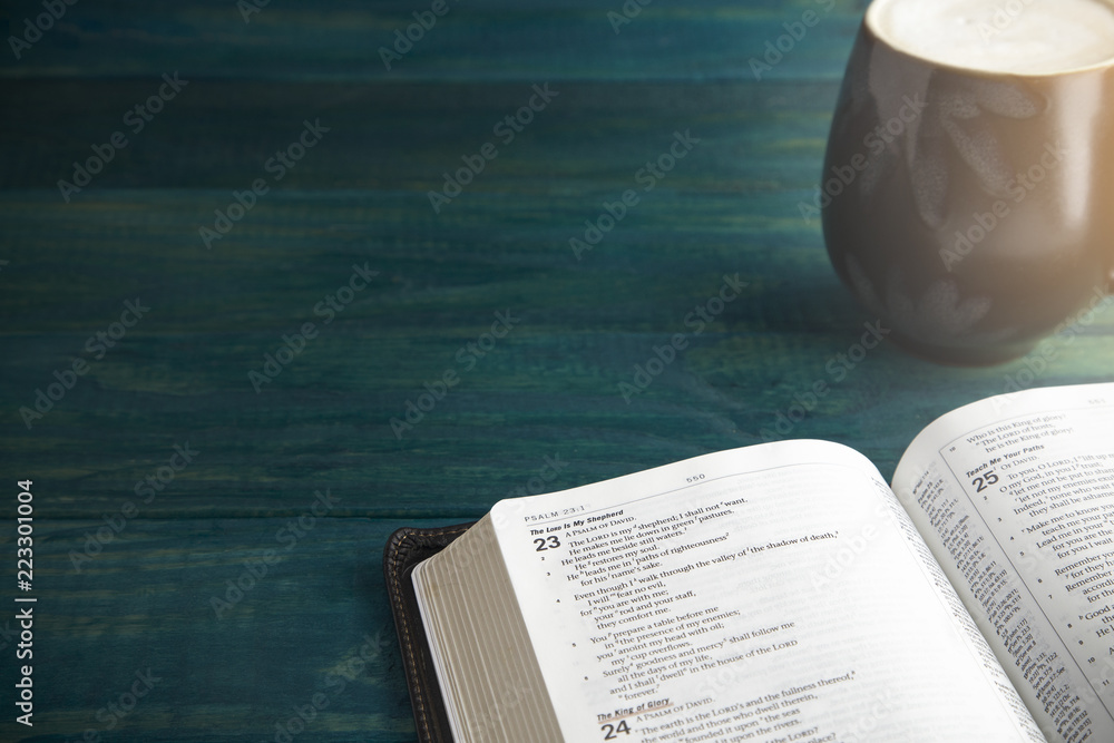Fototapeta premium Holy Bible on a Blue Wooden Table Out for Studying