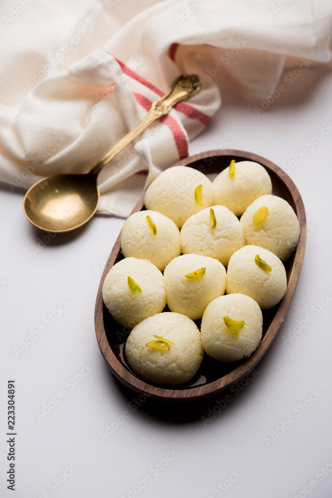 Indian Rasgulla or Rosogulla dessert/sweet served in a bowl. selective focus Indian Rasgulla or Rosogulla dessert/sweet served in a bowl. selective focus